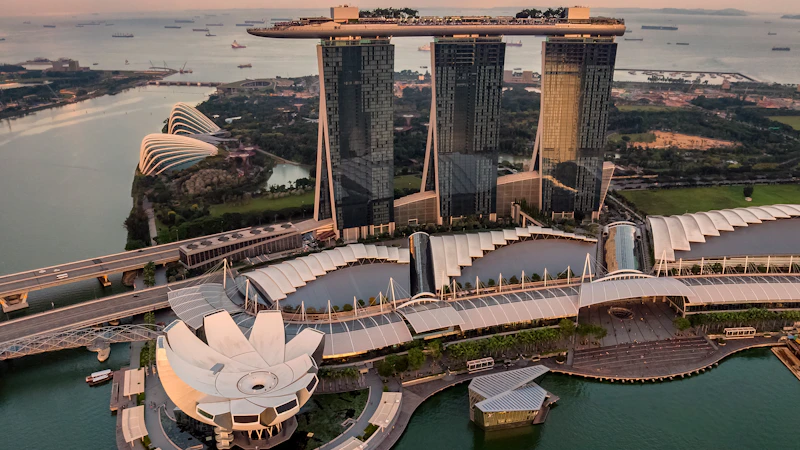Singapore Marina Bay skyline at dusk with illuminated buildings.